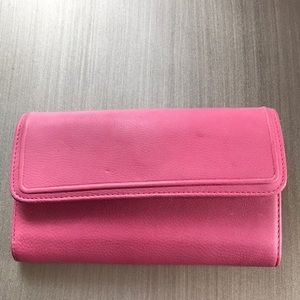 Rolf’s wallet. New and pink